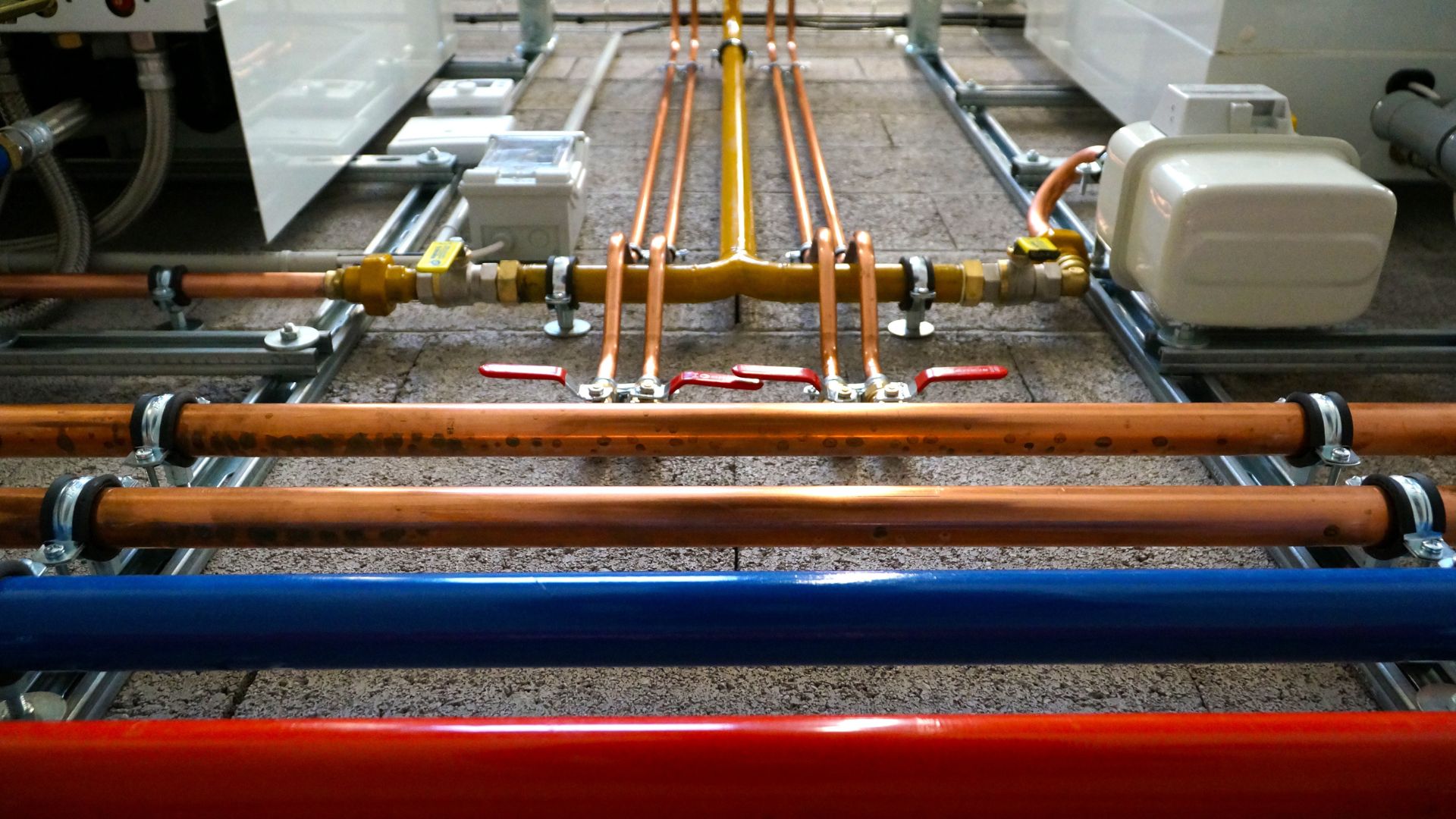 A row of pipes and valves in a building