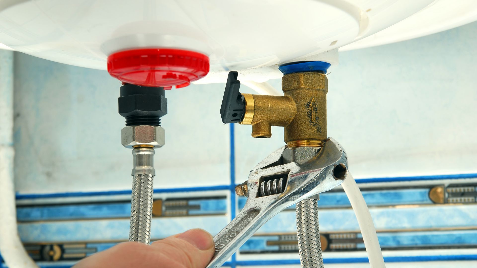 A close up of a person fixing a faucet